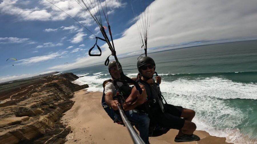 From Lisbon: Paragliding Tandem Flight - Shared transport and moving meeting points: the logistics that affect your day