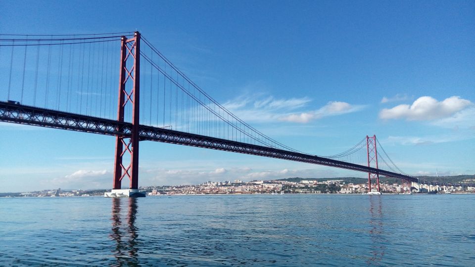 Lisbon: 2-Hour Sailing Yacht Cruise & Guided Tour w/2 drinks - São Jorge’s silhouette versus Expo-era Lisbon: old vs new, seen clearly